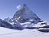 The Matterhorn towers over skiers on the Theodul glacier